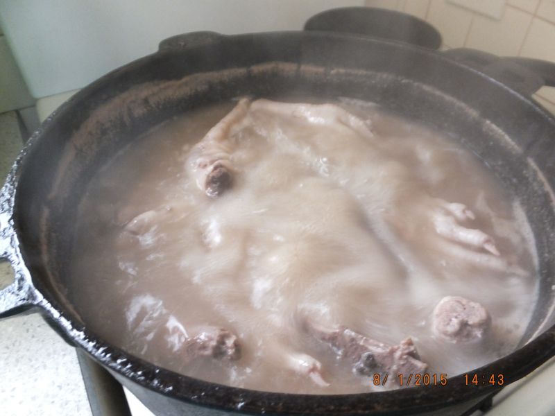 Reduce to the lowest heat possible and let it simmer away for eight to twelve hours depending how low you can get the heat. The water should be barely moving in the pot and definitely not bubbling away.